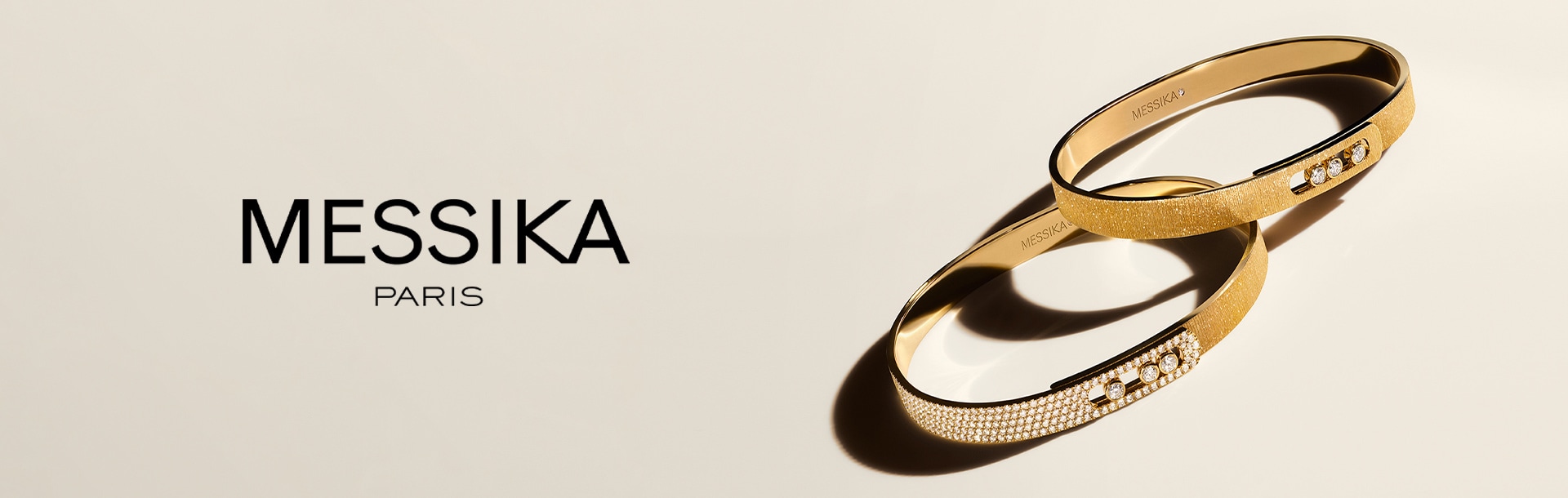 Two Messika bangles with Messika logo