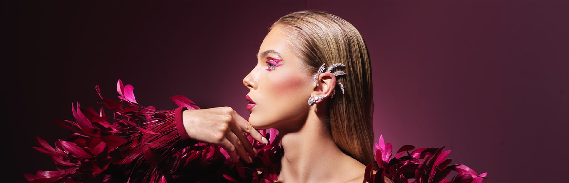Image of model wearing feathered pink outfit wearing Yeprem jewellery